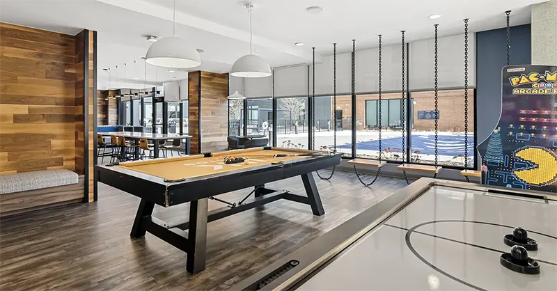Club and Game Room at The Link Evanston with pool table, lounge seating, kitchenette, large dining table, and TV area